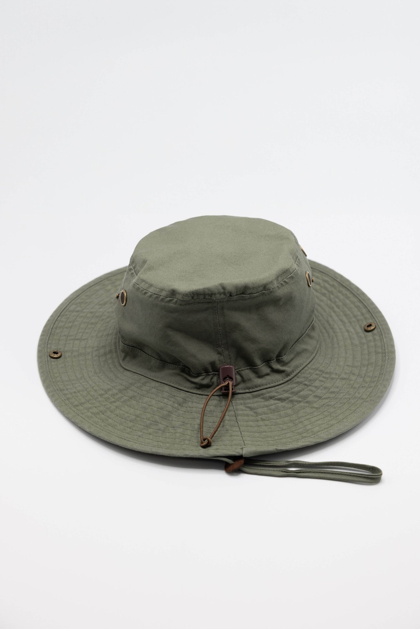 Green boonie hat made from organic cotton with wide brim and Creek bird embroidery